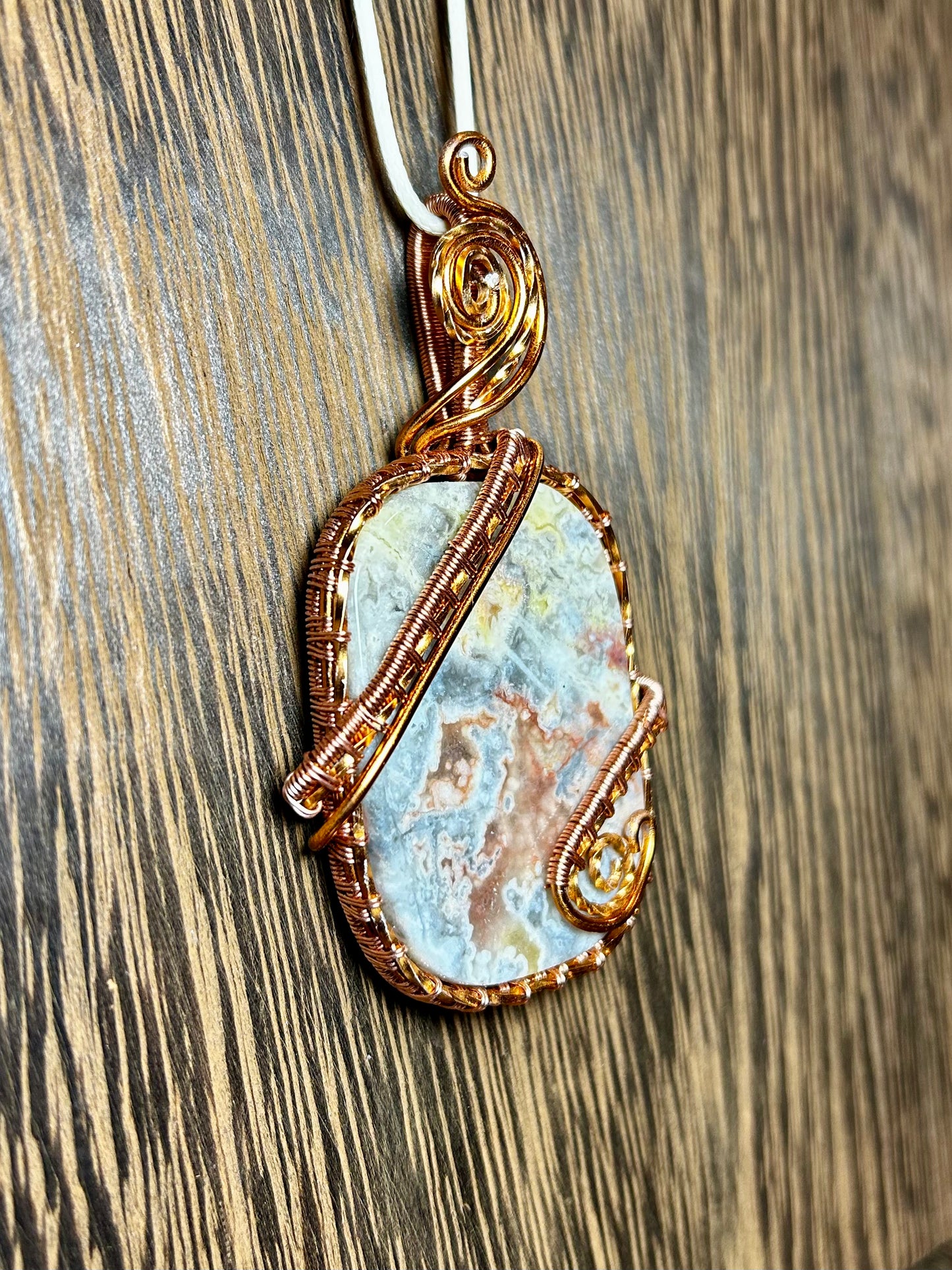 Crazy Lace Agate Wrapped In Copper Colored Wire