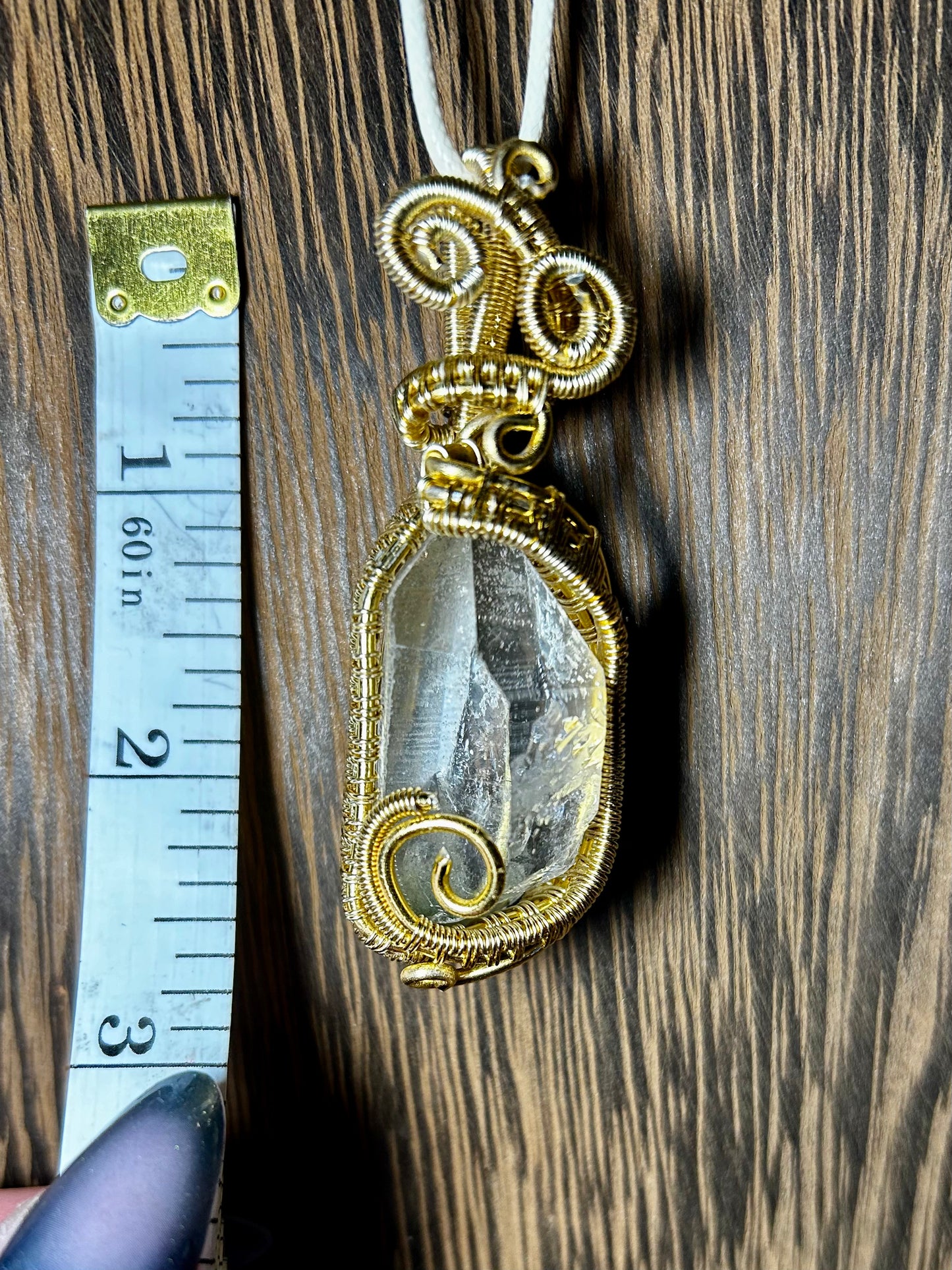 Clear Quartz Wrapped In Gold Colored Wiring